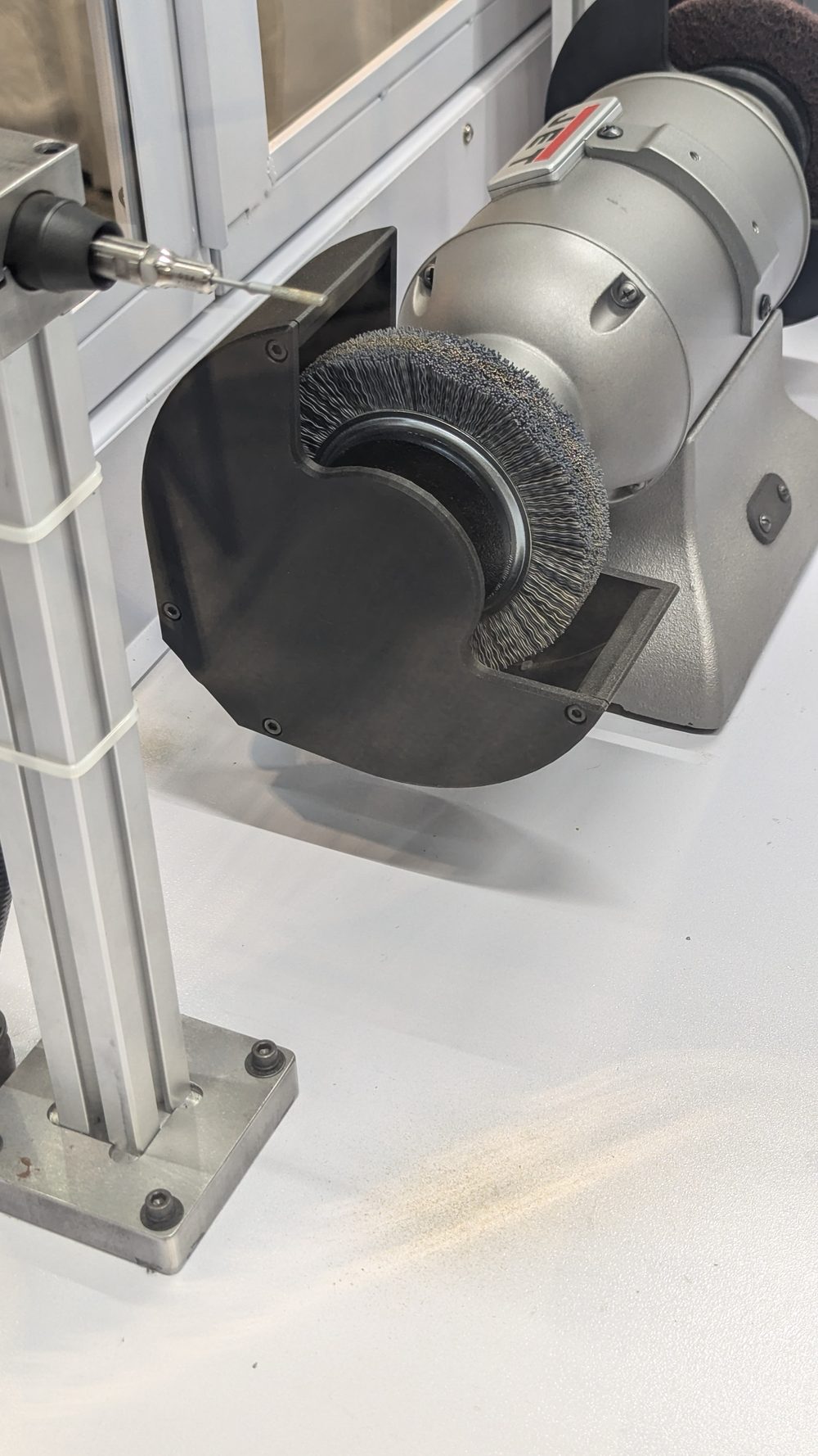Close view of an abrasive brush finishing station inside the robotic deburring cell