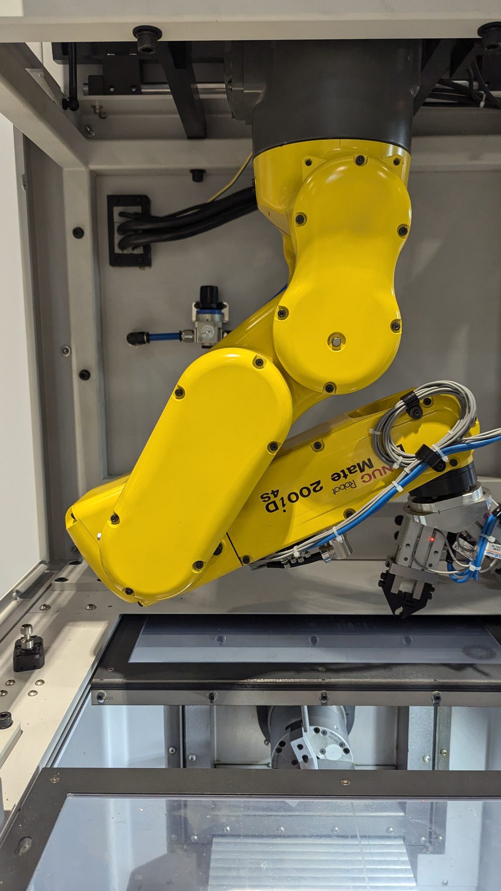 Close view of the FANUC LR Mate wrist with a dual pneumatic gripper end effector and routed air lines