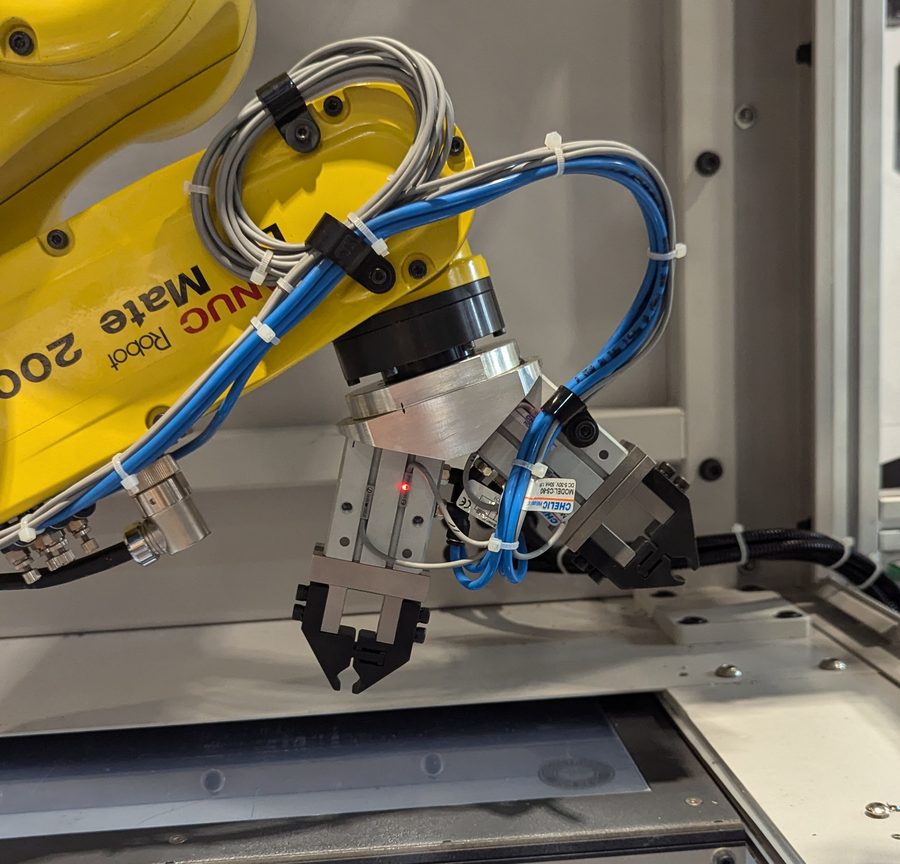 FANUC LR Mate wrist fitted with a dual pneumatic gripper end effector and routed air lines